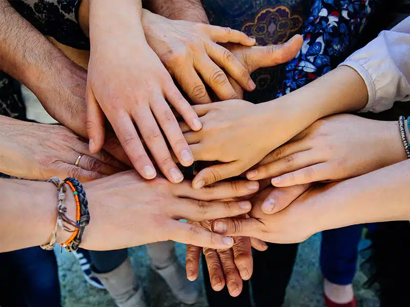 family joining hands after a successful intervention