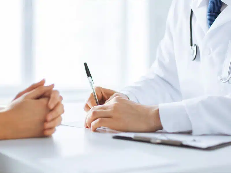 doctor sitting with patient explaining medication assisted treatment for alcoholism